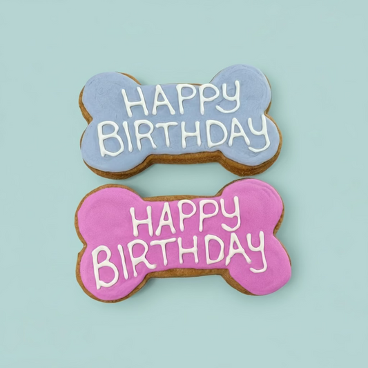 Two bone-shaped cookies with 'Happy Birthday' text 
