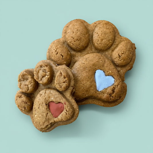 Dog treats shaped like a paw print with heart designs 